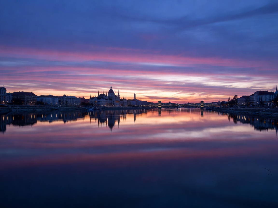 Twilight sky reflection over the Danube river and city skyline photography at blue hour